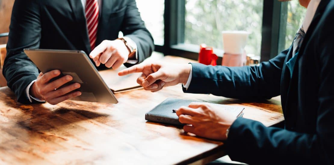 Two Businessman Sitting And Looking At Tablet, They Are Meeting two businessman sitting and looking at tablet, they are meeting about business plan, marketing and financial in the future. concept of business success, business meeting.
